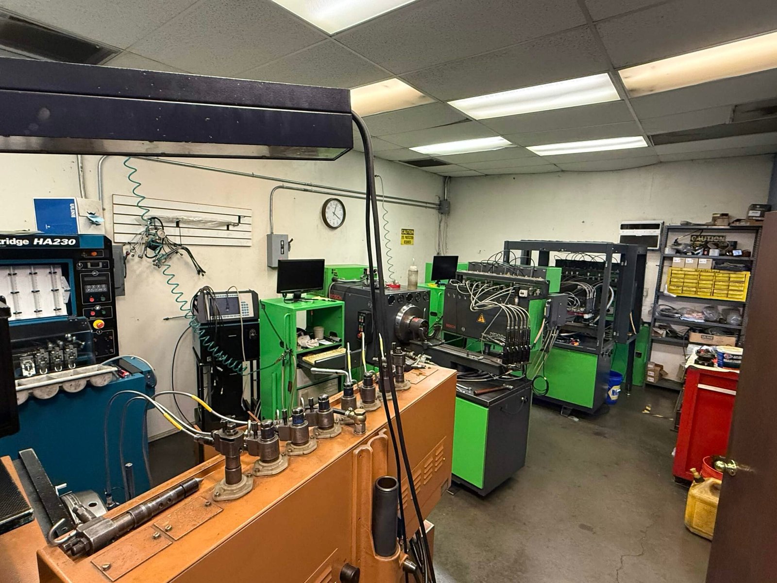 Overhead view of VFI diesel injection test room with multiple workbenches and equipment