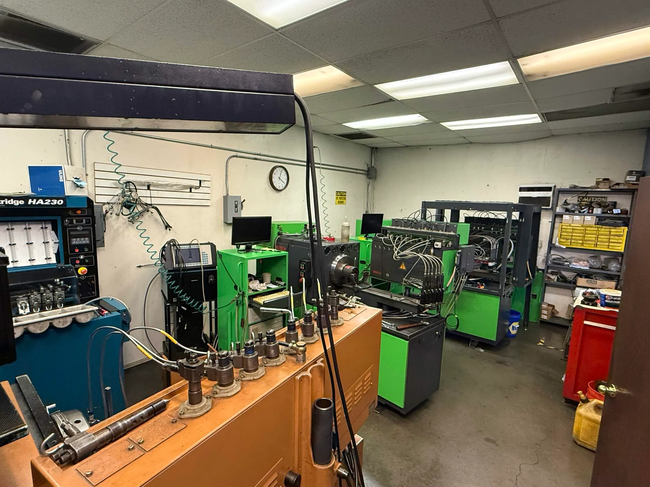 Overhead view of VFI diesel injection test room with multiple workbenches and equipment