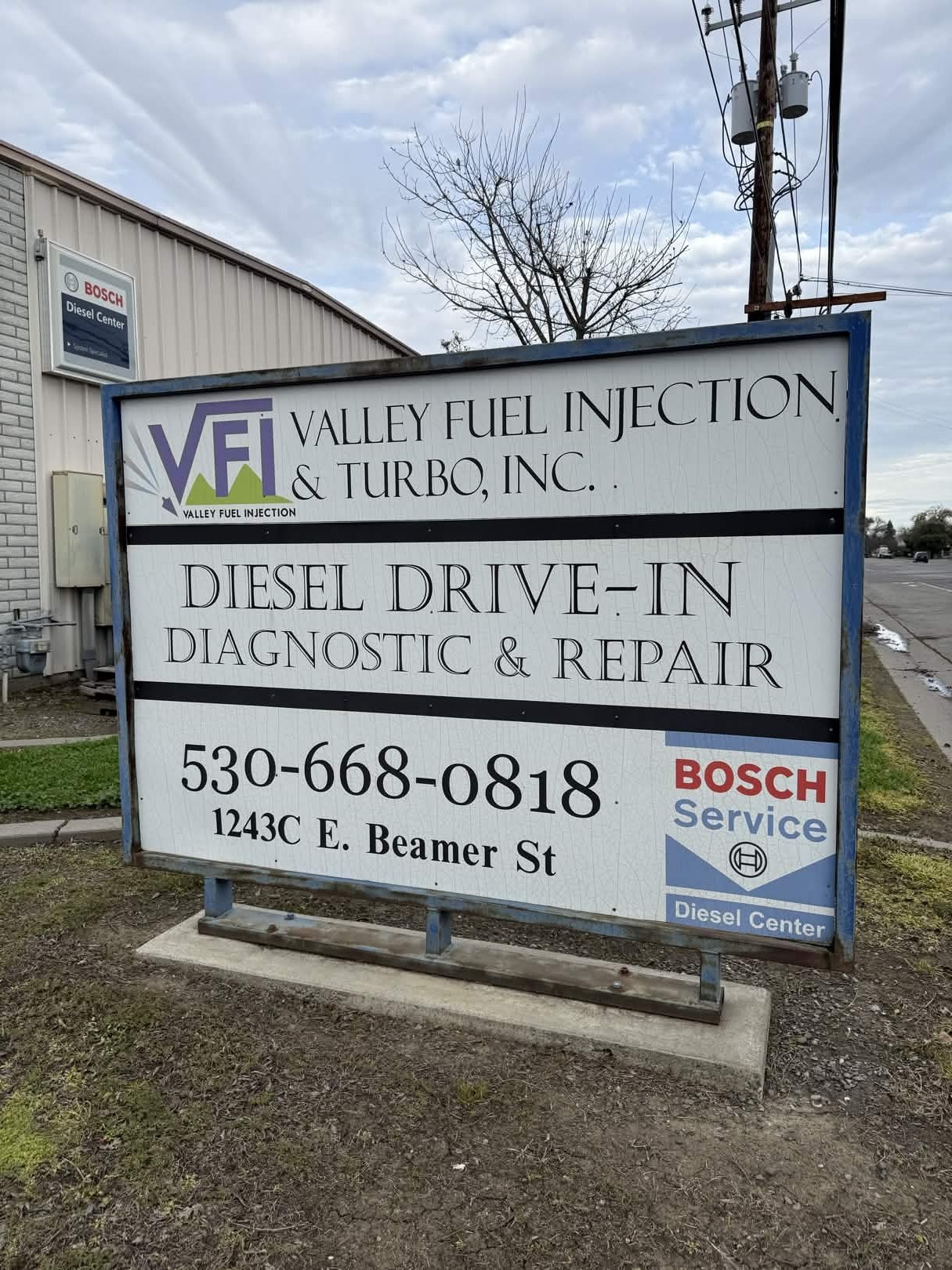 Valley Fuel Injection business sign with shop building in background — Woodland, California