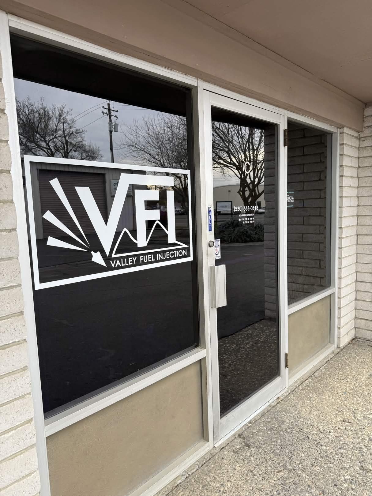 Valley Fuel Injection front entrance with logo and authorized dealer stickers