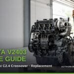 A complete Kubota V2403 diesel engine with turbocharger on a wooden pallet in a workshop, an orange excavator in the background. Title reads "Kubota V2403 Engine Guide: Problems, Cat C2.4 Crossover, Replacement".