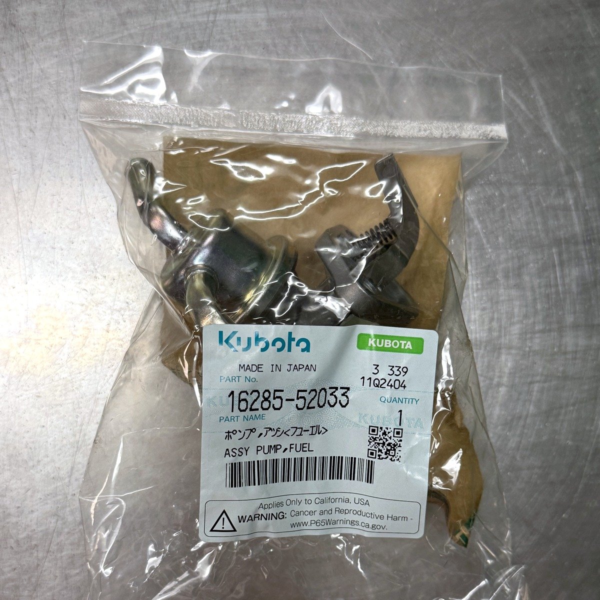 Genuine Kubota 16285-52033 mechanical fuel lift pump in its Kubota bag